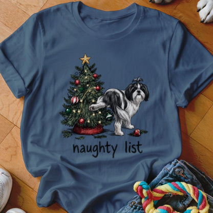 Blue crewneck t-shirt featuring a graphic of a black and white dog lifting its leg against a decorated Christmas tree with the text "naughty list" below.