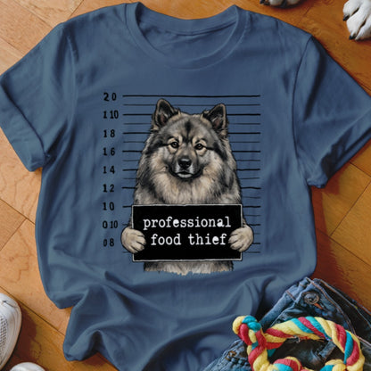 Keeshond dog mugshot graphic reads "professional food thief".