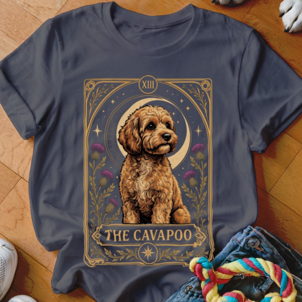 A dark grey t-shirt featuring a tarot card graphic of a Cavapoo with the text The Cavapoo.