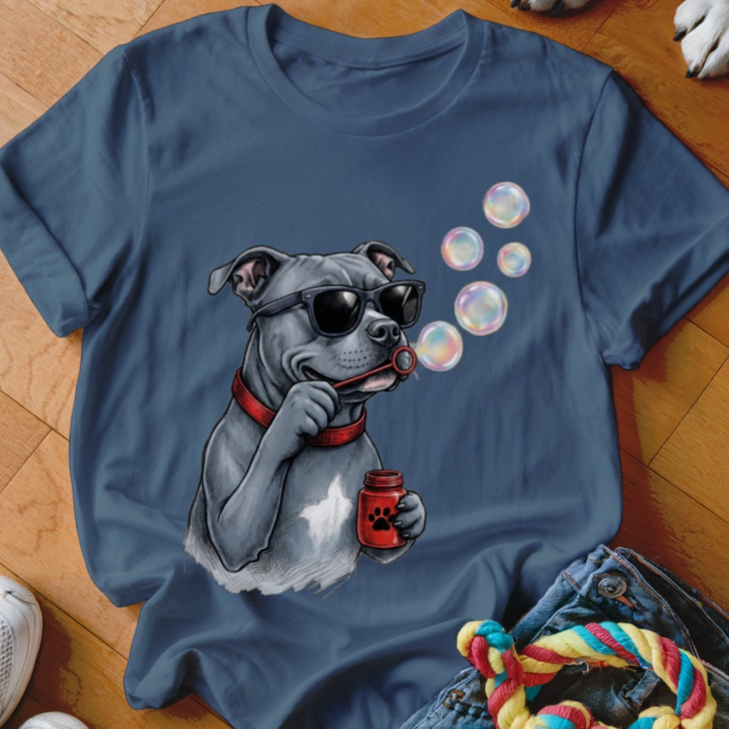 A blue crew-neck t-shirt featuring a graphic of a gray pitbull wearing sunglasses and blowing soap bubbles.
