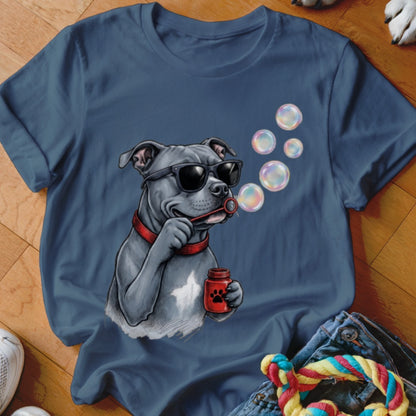 A blue crew-neck t-shirt featuring a graphic of a gray pitbull wearing sunglasses and blowing soap bubbles.