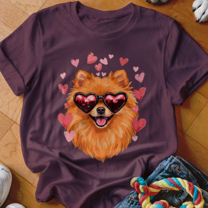 Dark purple t-shirt featuring a graphic of a Pomeranian wearing heart-shaped sunglasses surrounded by pink hearts.