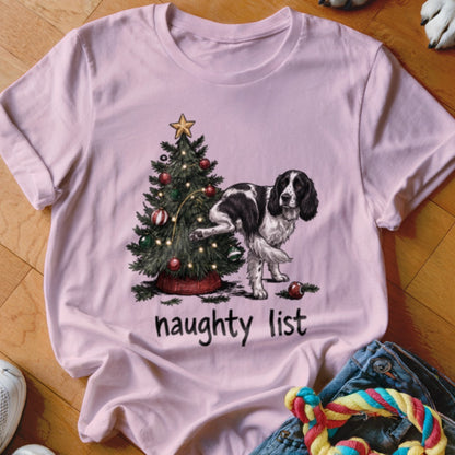 English Springer Spaniel marking a Christmas tree with "naughty list" text below.