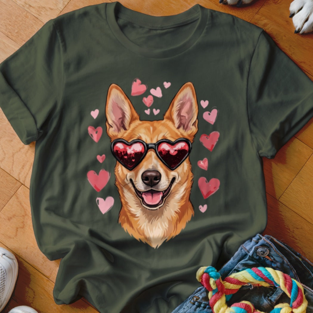 A dark green t-shirt featuring a graphic of a smiling dog wearing heart-shaped sunglasses, surrounded by pink hearts.