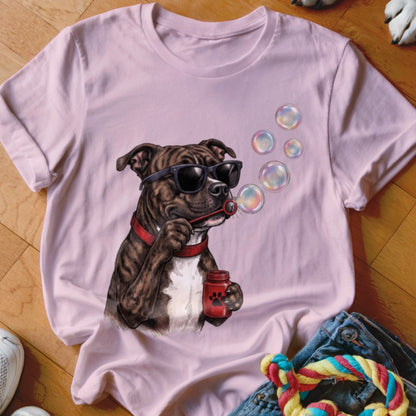 Light pink short-sleeve t-shirt featuring a graphic of a brindle dog wearing sunglasses and blowing bubbles.