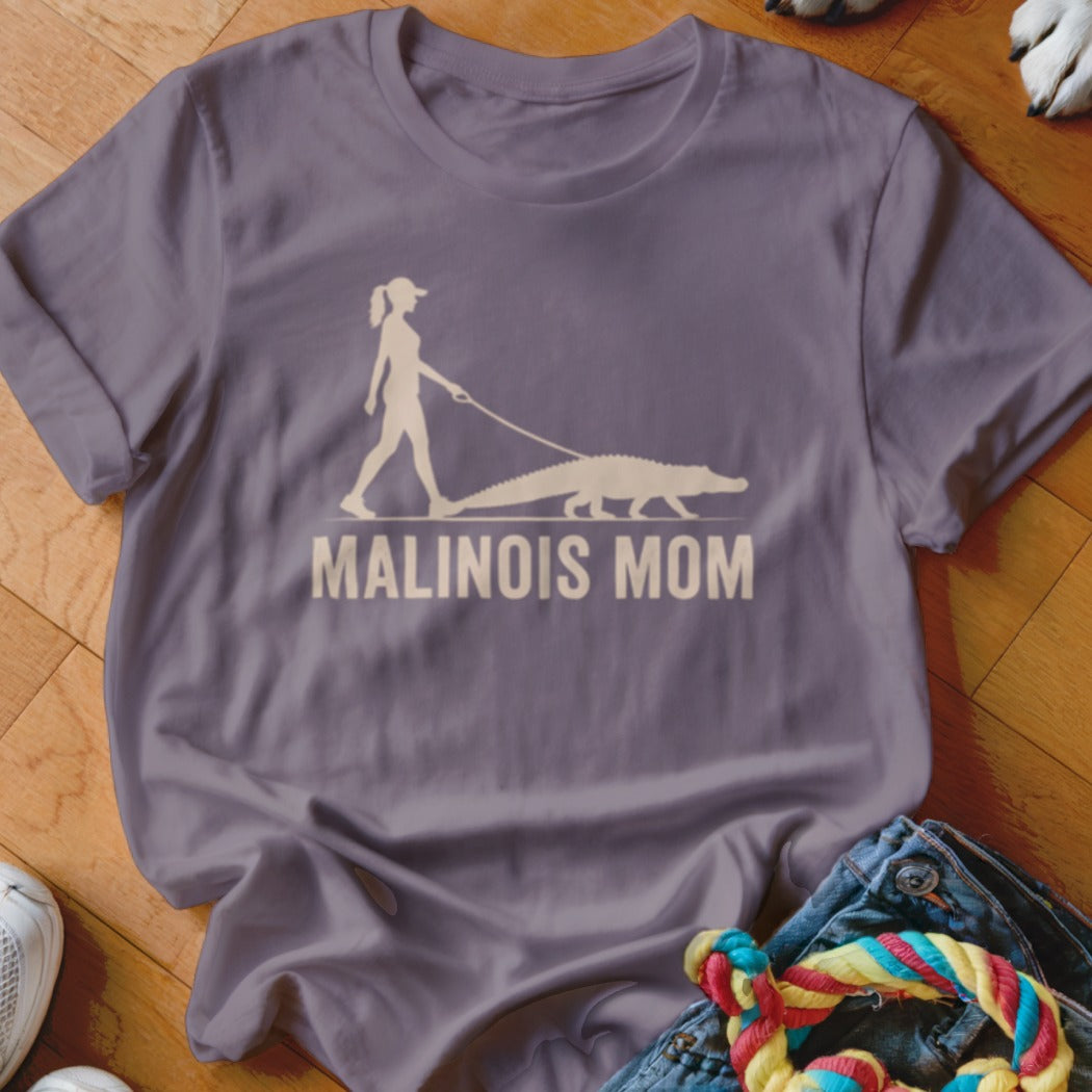 Graphic of person walking a crocodile on leash with text "MALINOIS MOM".