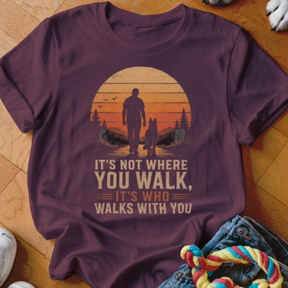 T-shirt with sunset graphic of person and dog walking, text: "It's not where you walk, it's who walks with you."