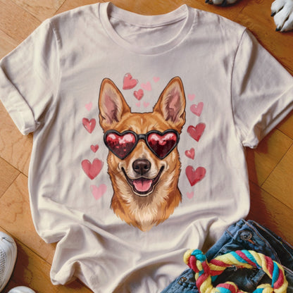 Light beige crewneck t-shirt featuring an illustration of a smiling dog wearing heart-shaped sunglasses surrounded by pink hearts.