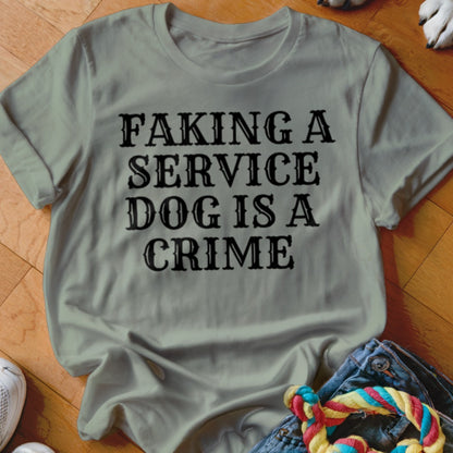 Light gray t-shirt with black text that reads "Faking a service dog is a crime".