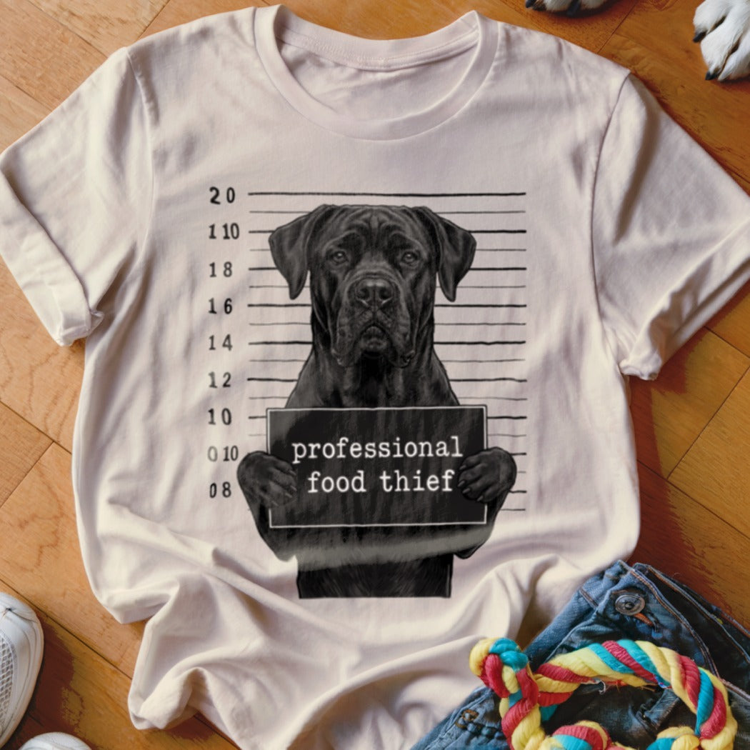 White t-shirt with a black dog mugshot design: "professional food thief".