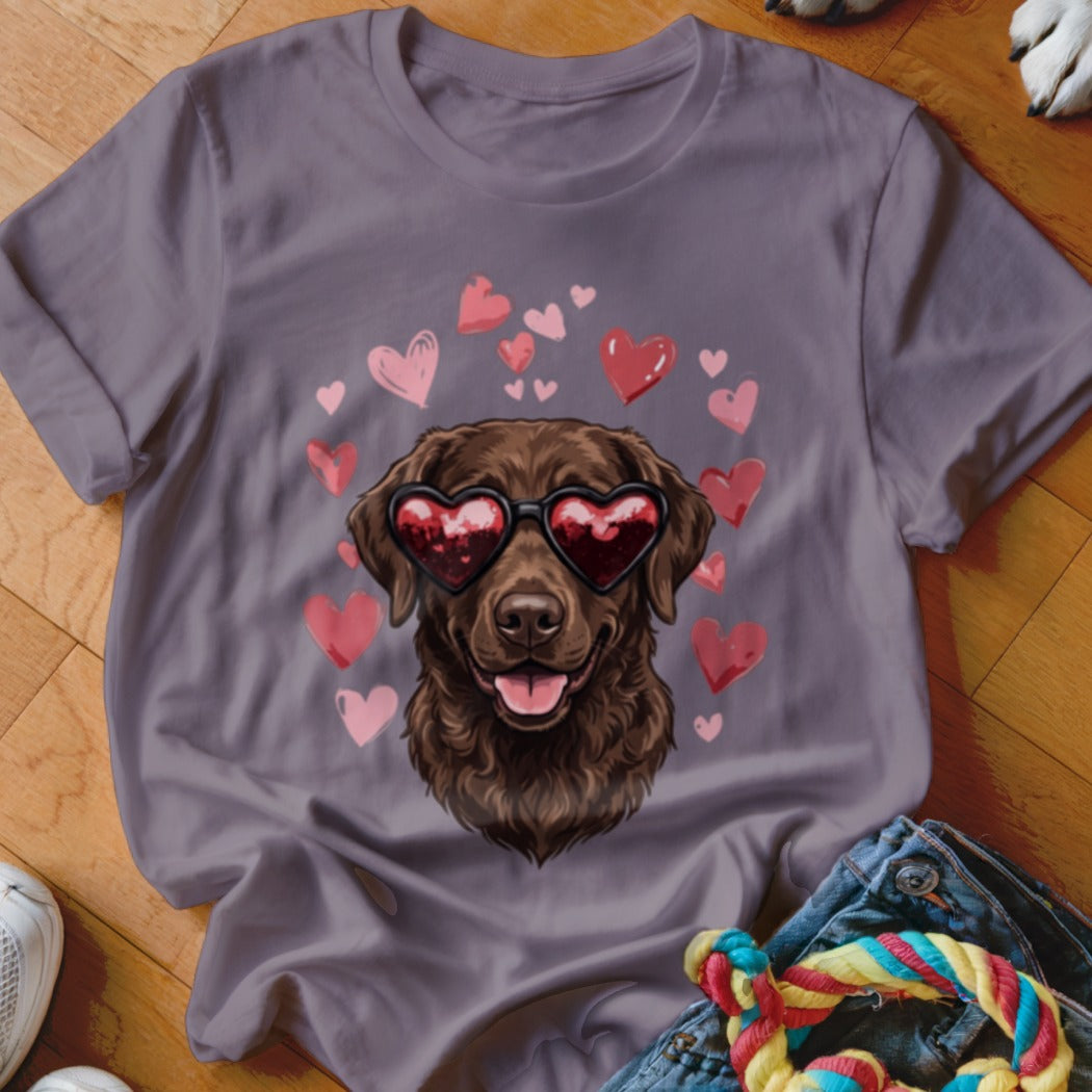 Purple t-shirt featuring a brown dog wearing heart-shaped sunglasses surrounded by floating pink hearts.