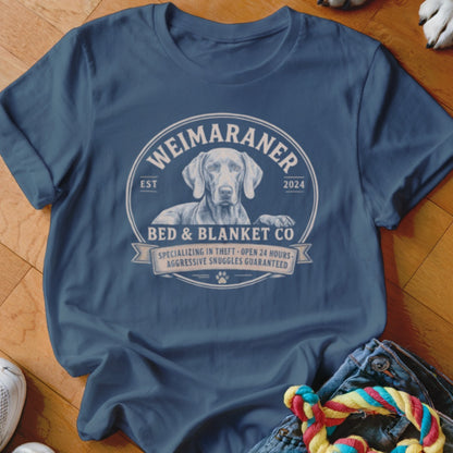 Weimaraner dog graphic with "Bed & Blanket Co" text on a navy t-shirt.