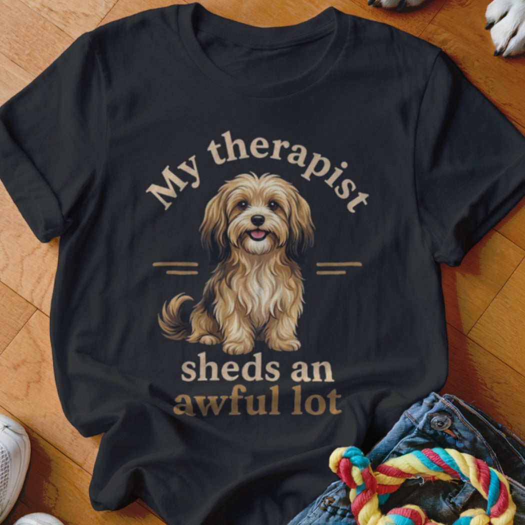 Black t-shirt with illustration of a fluffy dog and text "My therapist sheds an awful lot".