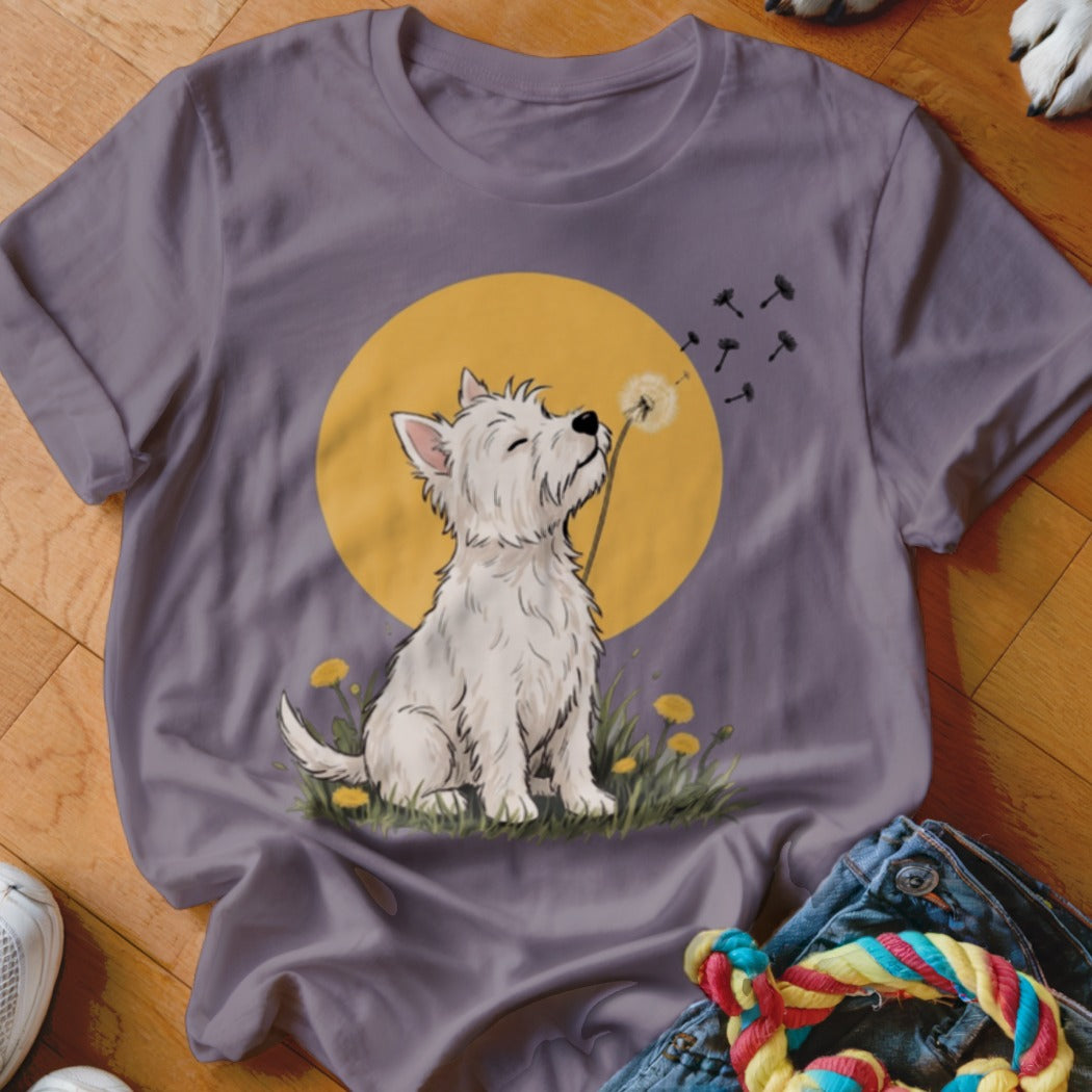 A purple crewneck t-shirt featuring an illustration of a white West Highland Terrier blowing dandelion seeds.