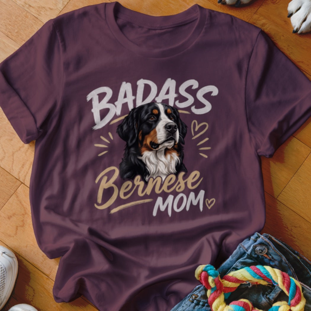 A dark purple t-shirt featuring a graphic of a Bernese Mountain Dog with the text BADASS Bernese MOM.
