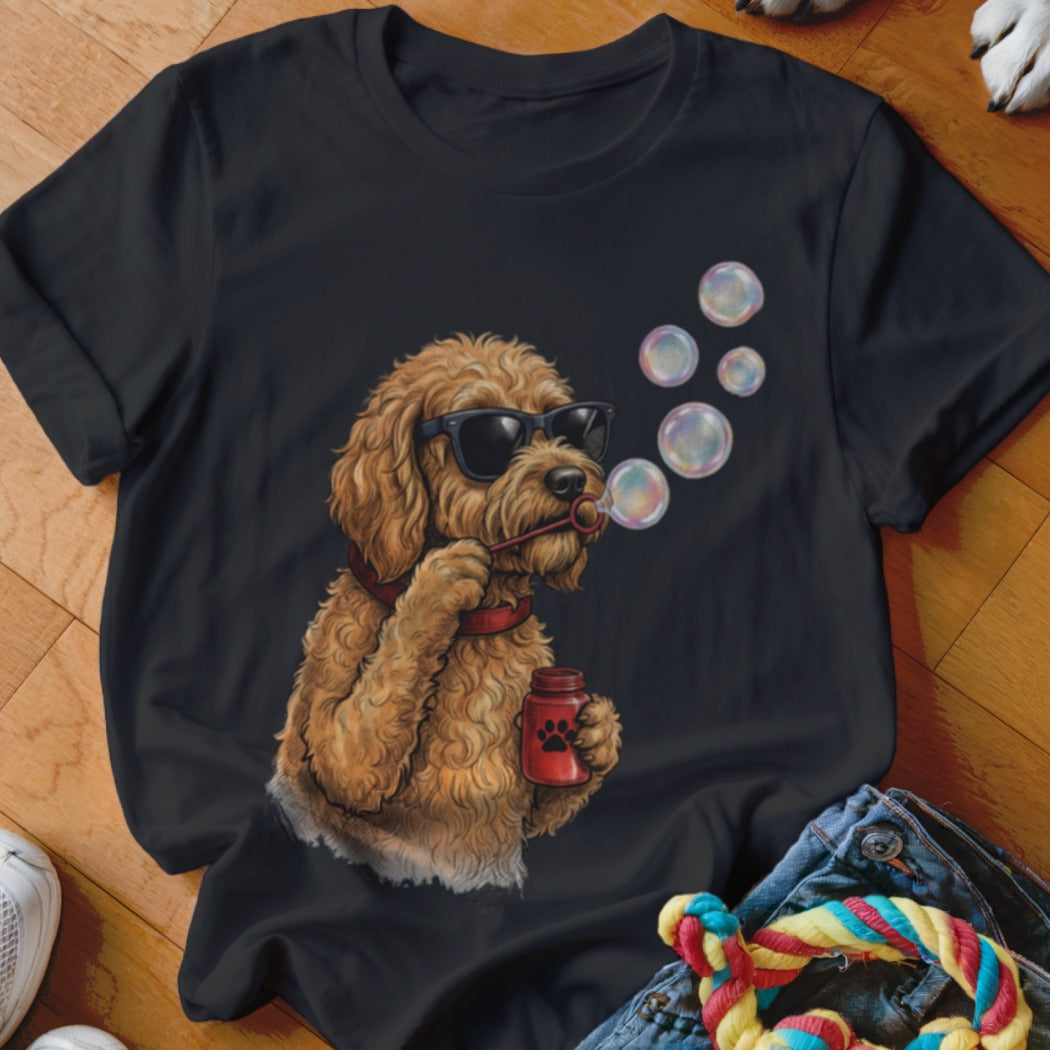 Black t-shirt featuring an illustration of a fluffy golden dog wearing sunglasses and blowing bubbles.