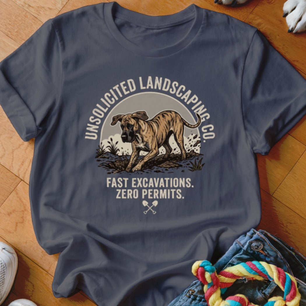 T-shirt graphic with a dog digging dirt, text reads "UNSOLICITED LANDSCAPING CO. FAST EXCAVATIONS. ZERO PERMITS."