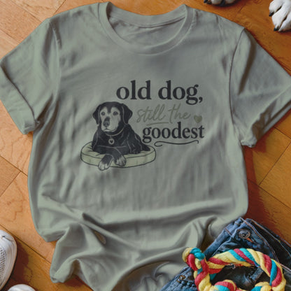 T-shirt with graphic of a black dog on a pillow and text "old dog, still the goodest".