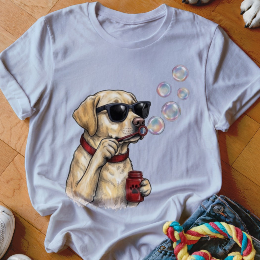 White t-shirt featuring an illustration of a yellow labrador wearing sunglasses and blowing soap bubbles.