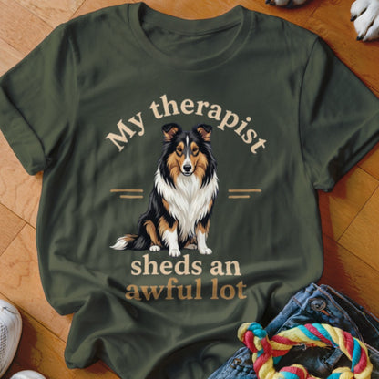 Olive green t-shirt with a Shetland Sheepdog and text "My therapist sheds an awful lot".