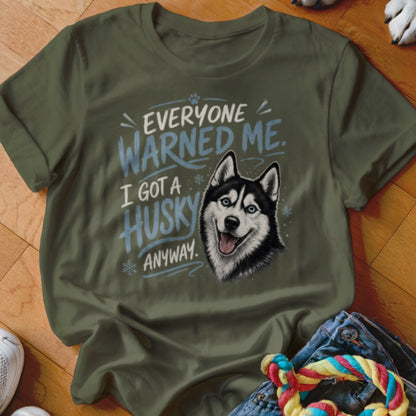 Green t-shirt with "Everyone warned me. I got a husky anyway." text and husky illustration.