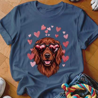 A dark blue t-shirt featuring an illustration of a brown dog wearing heart-shaped sunglasses, surrounded by pink hearts.