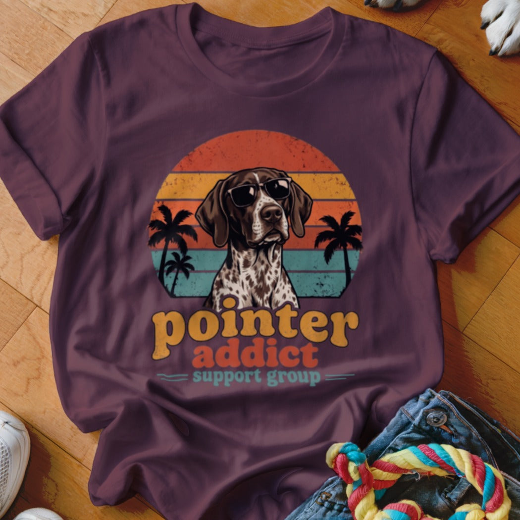 Maroon t-shirt featuring a retro sunset design with a pointer dog wearing sunglasses and palm trees.