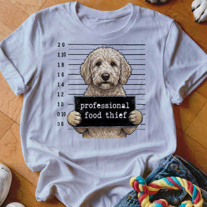 Goldendoodle mugshot with sign reading "professional food thief."