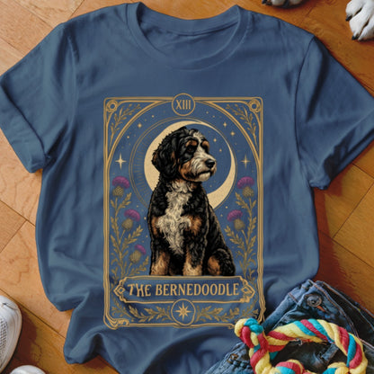 Dark blue t-shirt featuring a tarot card graphic of a Bernedoodle and the text The Bernedoodle.
