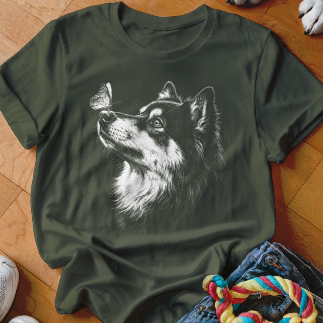Dark green t-shirt featuring a white sketch of a husky dog looking at a butterfly.