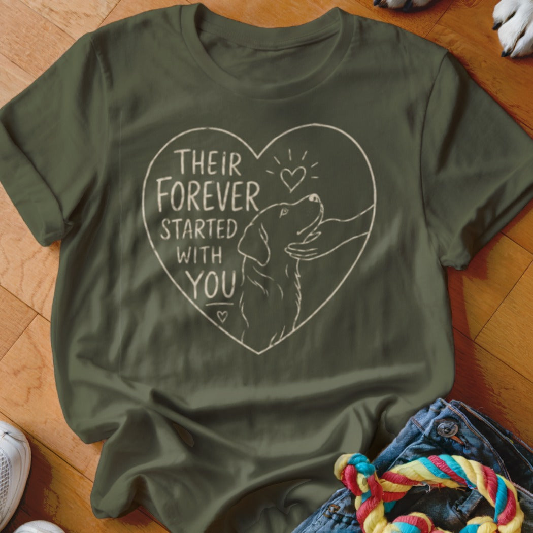 Green t-shirt with line art inside a heart: dog being petted, text "Their Forever Started With You".