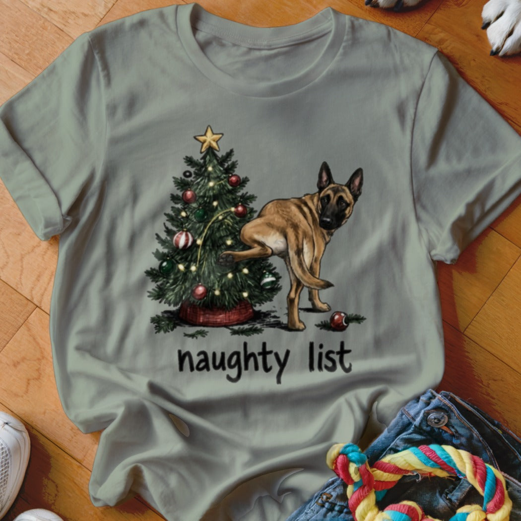 A dog lifts its leg near a Christmas tree, text reads "naughty list."
