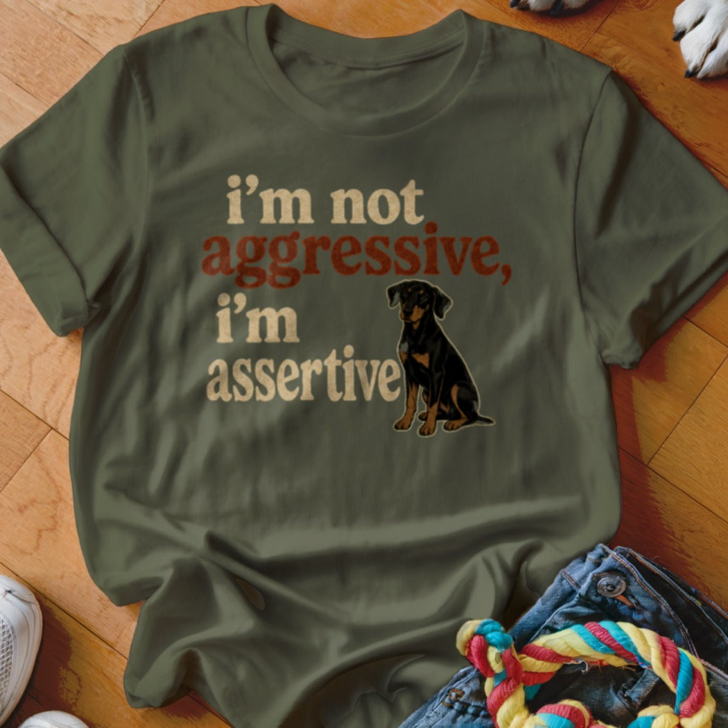 Olive green t-shirt with "I'm not aggressive, I'm assertive" text and a dog graphic.