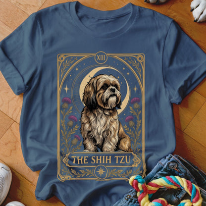 A blue t-shirt displays a tarot card graphic featuring a Shih Tzu and purple flowers.