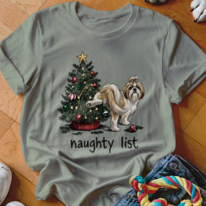 Sage green t-shirt featuring a Shih Tzu dog lifting its leg on a Christmas tree with the text "naughty list".