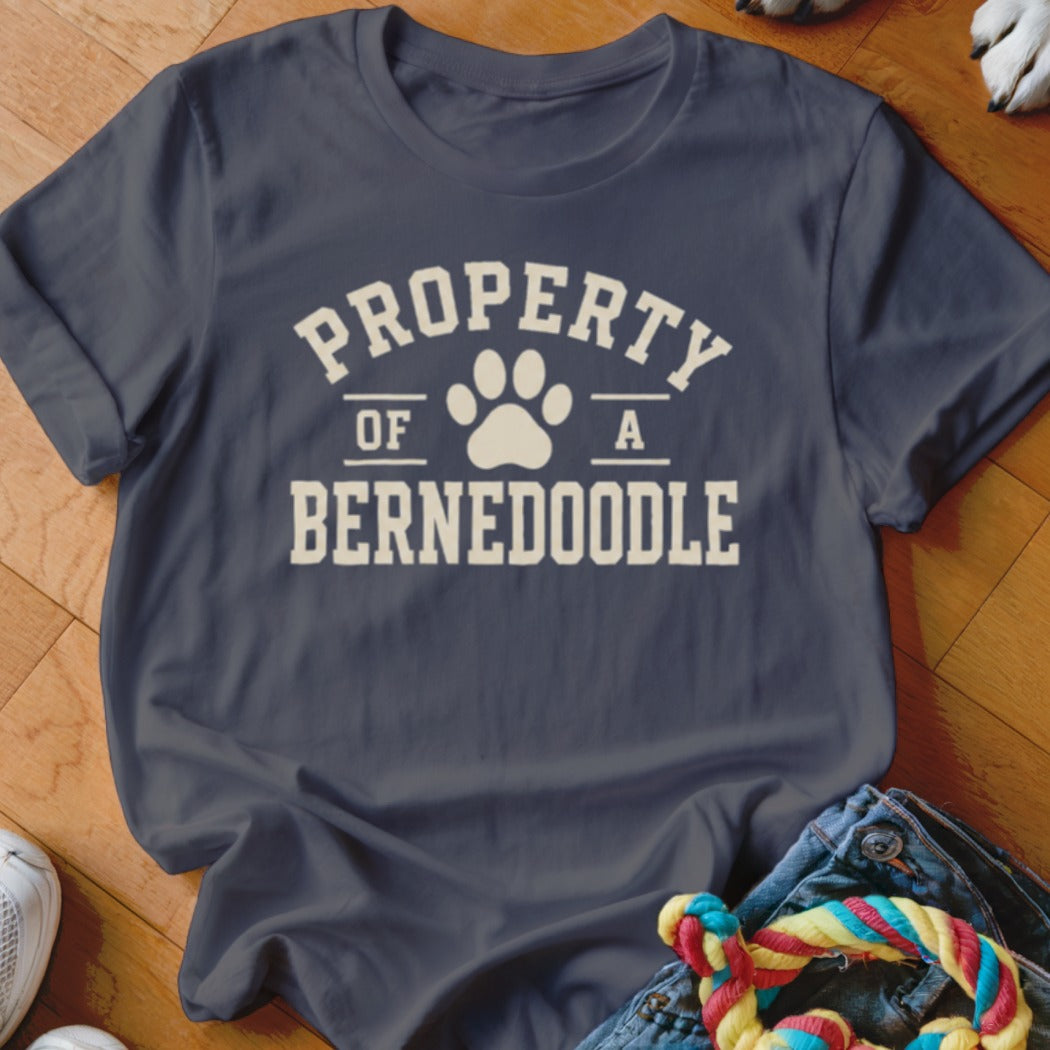 Navy t-shirt with "Property of a Bernedoodle" and paw print graphic.