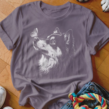 A purple crewneck t-shirt featuring a white line art graphic of a dog looking at a butterfly.