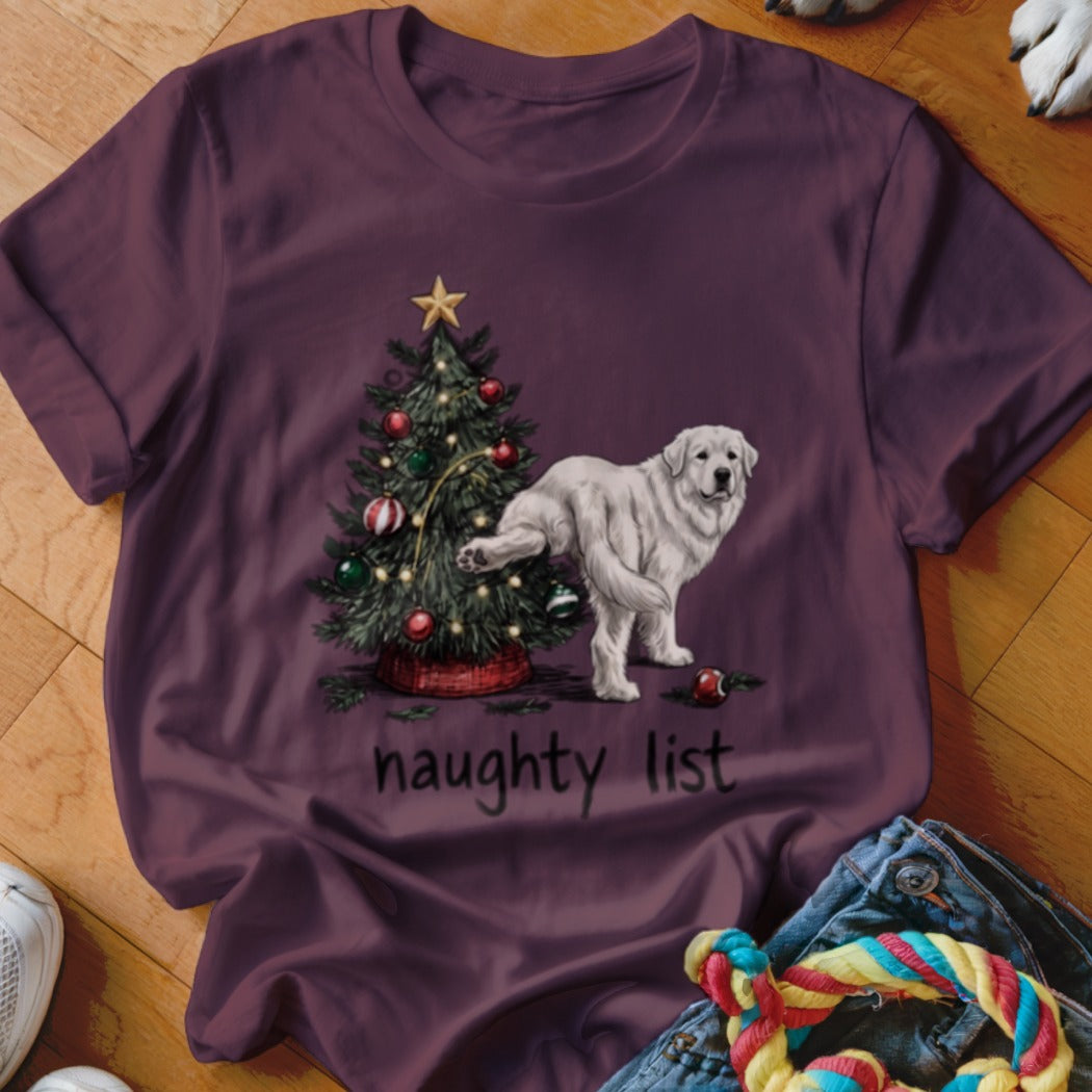A dark purple t-shirt features a graphic of a dog lifting its leg against a Christmas tree, with the text "naughty list".
