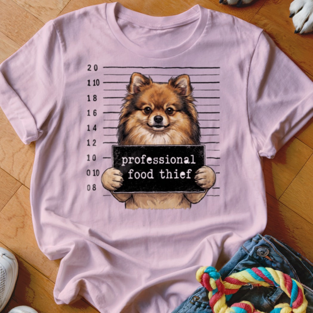 Pomeranian dog mugshot with text "professional food thief."