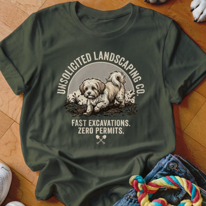 Olive green t-shirt with "Unsolicited Landscaping Co. Fast Excavations. Zero Permits." text and dog graphic.