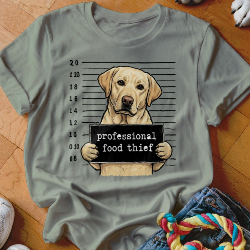 Labrador retriever mugshot with "professional food thief" sign
