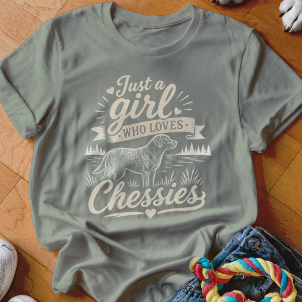 Gray t-shirt with text "Just a girl WHO LOVES Chessies" and a dog illustration.