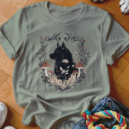 Sage green crewneck t-shirt featuring a graphic of a black dog surrounded by mushrooms and foliage.