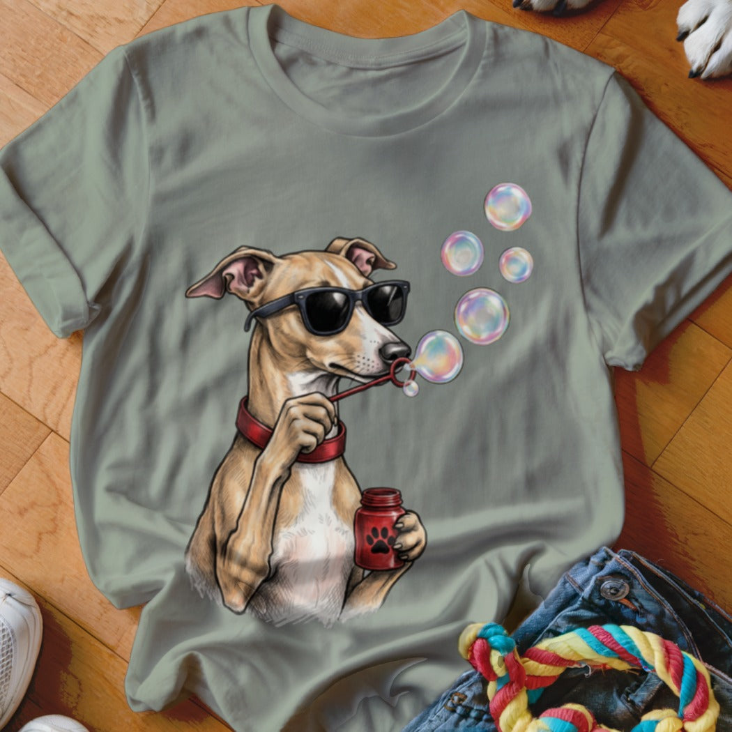Sage green t-shirt featuring an illustrated dog wearing sunglasses and blowing soap bubbles.