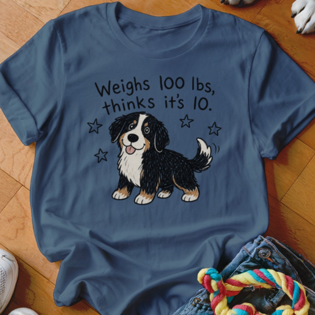 Blue t-shirt with cartoon Bernese Mountain Dog and text "Weighs 100 lbs, thinks it's 10."
