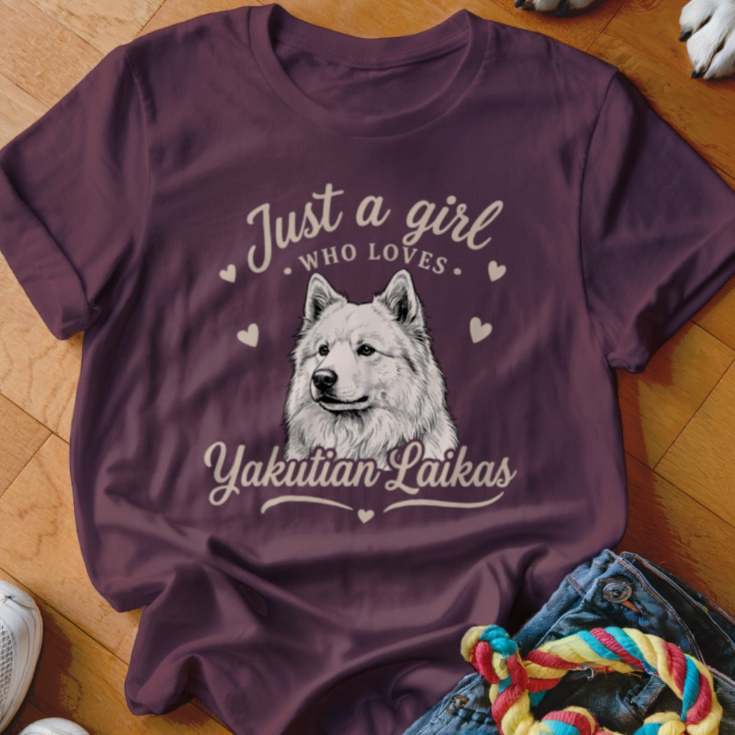 A dark purple t-shirt featuring a graphic of a white Yakutian Laika and text reading Just a girl who loves Yakutian Laikas.