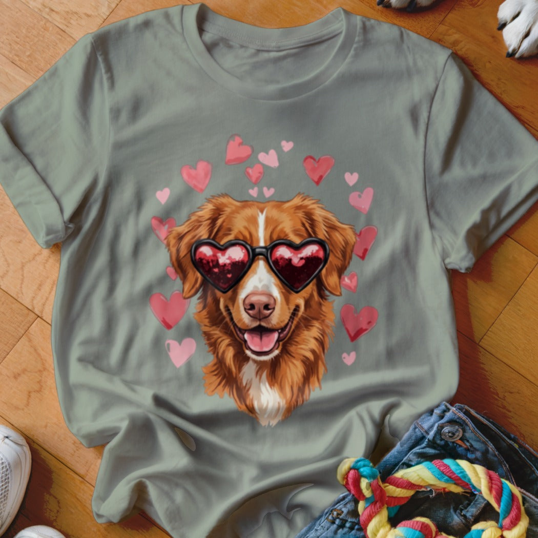 Sage green crewneck t-shirt featuring an illustration of a golden dog wearing heart-shaped sunglasses surrounded by pink hearts.