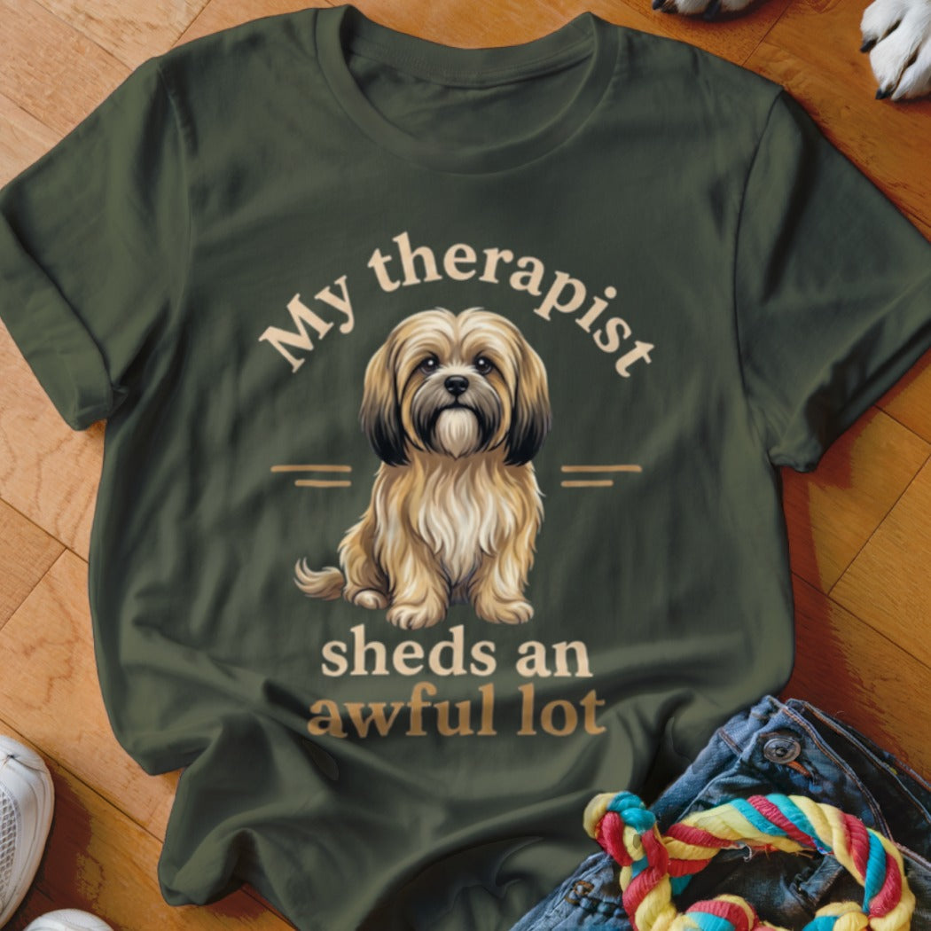 Green t-shirt with a sitting dog and text "My therapist sheds an awful lot."