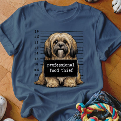 Dog mugshot with "professional food thief" on the sign.