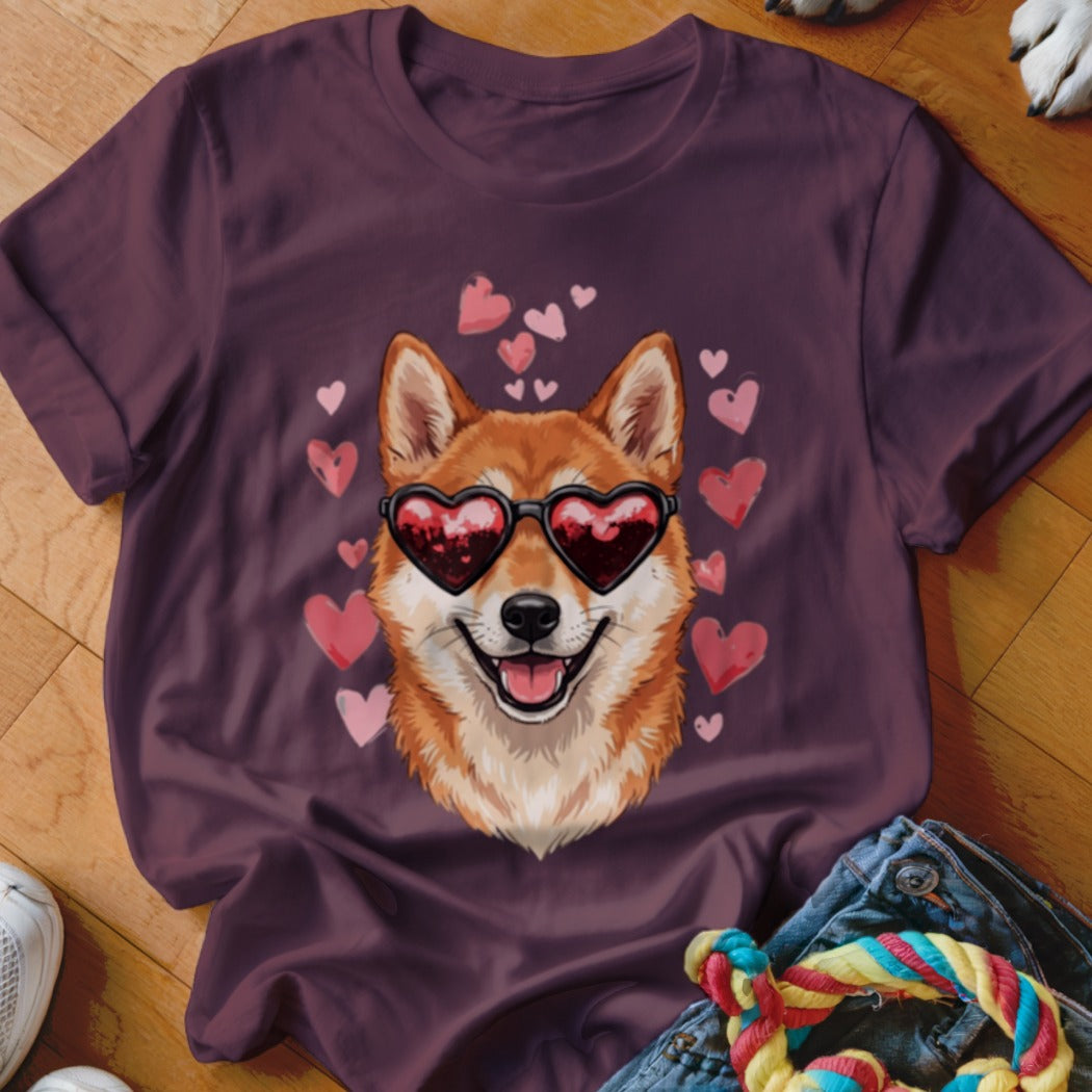 A dark purple t-shirt featuring a graphic of a Shiba Inu wearing heart-shaped sunglasses surrounded by pink hearts.